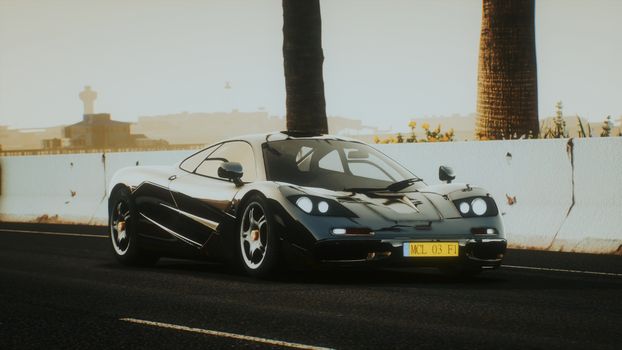 A luxurious black sports car parked by the road at sunset, exuding style and sophistication.