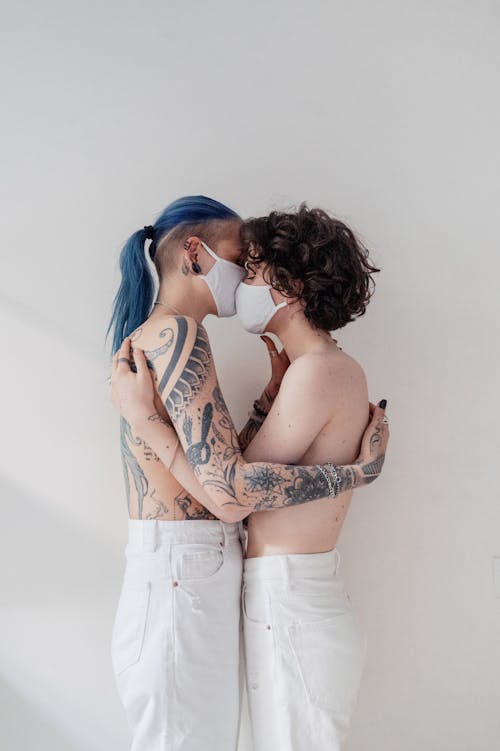 Topless Women Wearing Face Mask Standing Face to Face