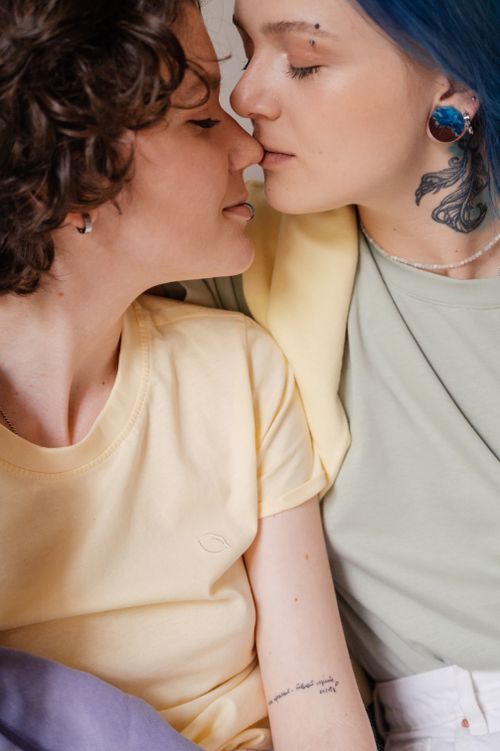 Free A tender moment captured between two tattooed women, showcasing love and affection. Stock Photo