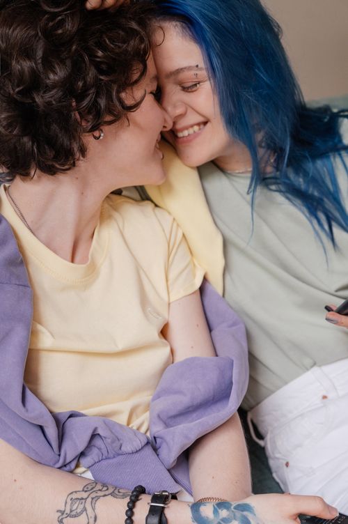 Free A joyful LGBTQ+ couple sharing an intimate and affectionate moment indoors. Stock Photo
