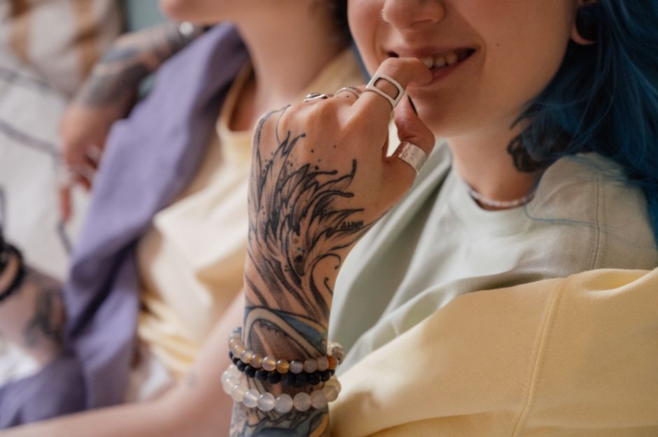 Hand wearing several stacked rings in a lifestyle setting