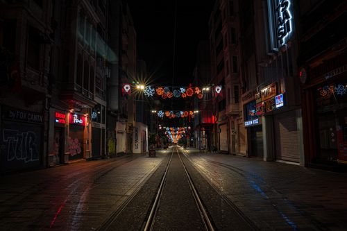 Free Empty Istiklal Street in Istanbul at night, adorned with festive lights and tram tracks. Stock Photo