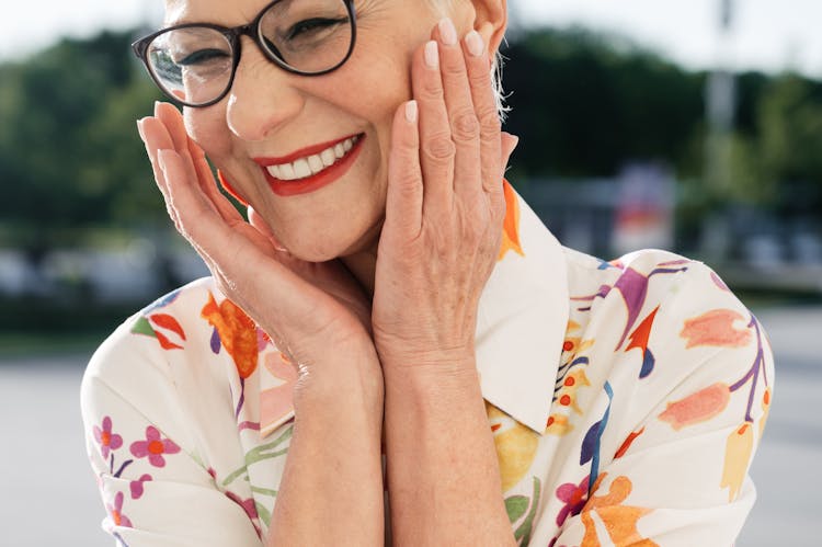 A Woman Smiling While Touching Face