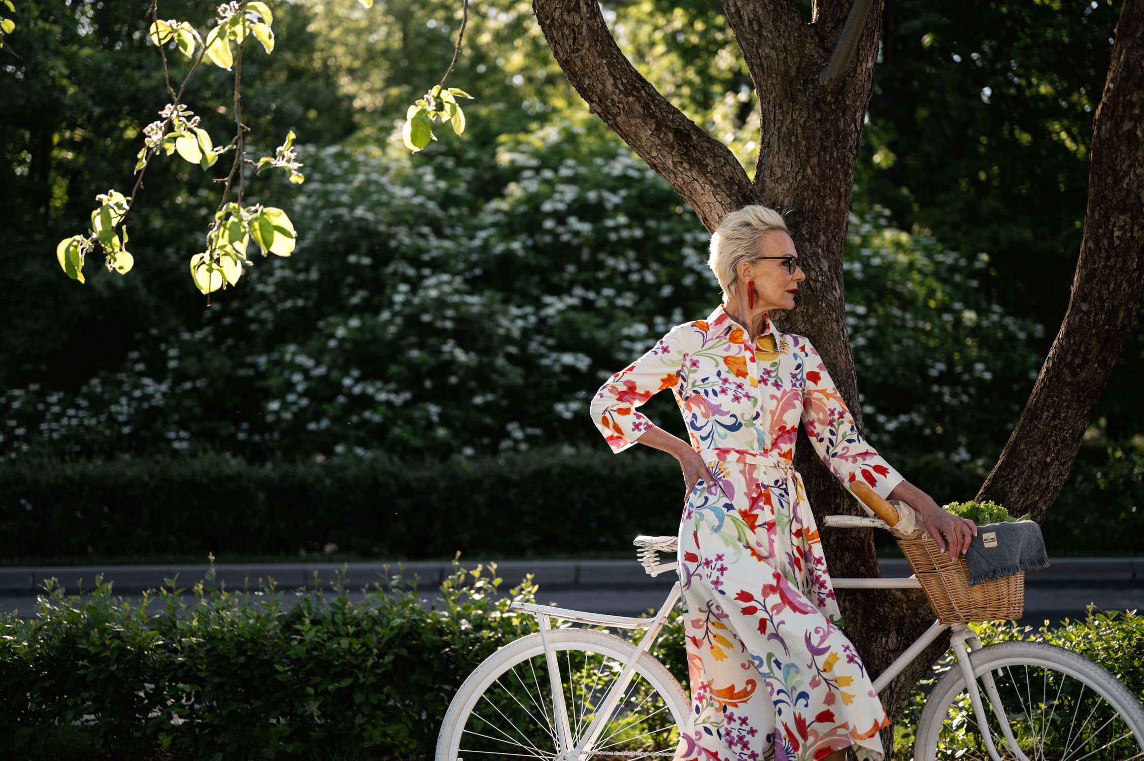 A Stylish Woman Standing beside a Bicycle · Free Stock Photo