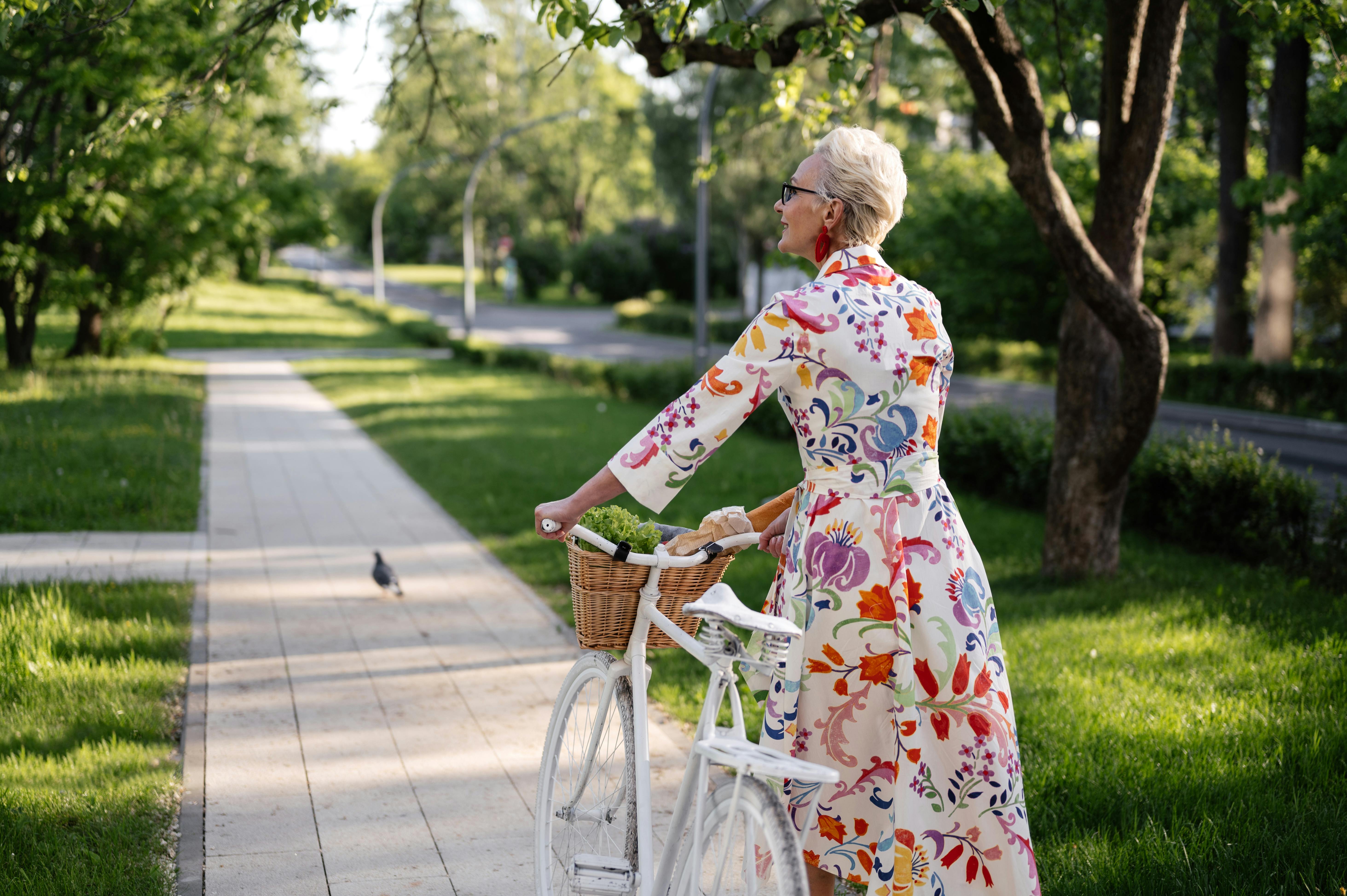 woman in floral dress walking at the sidewalk