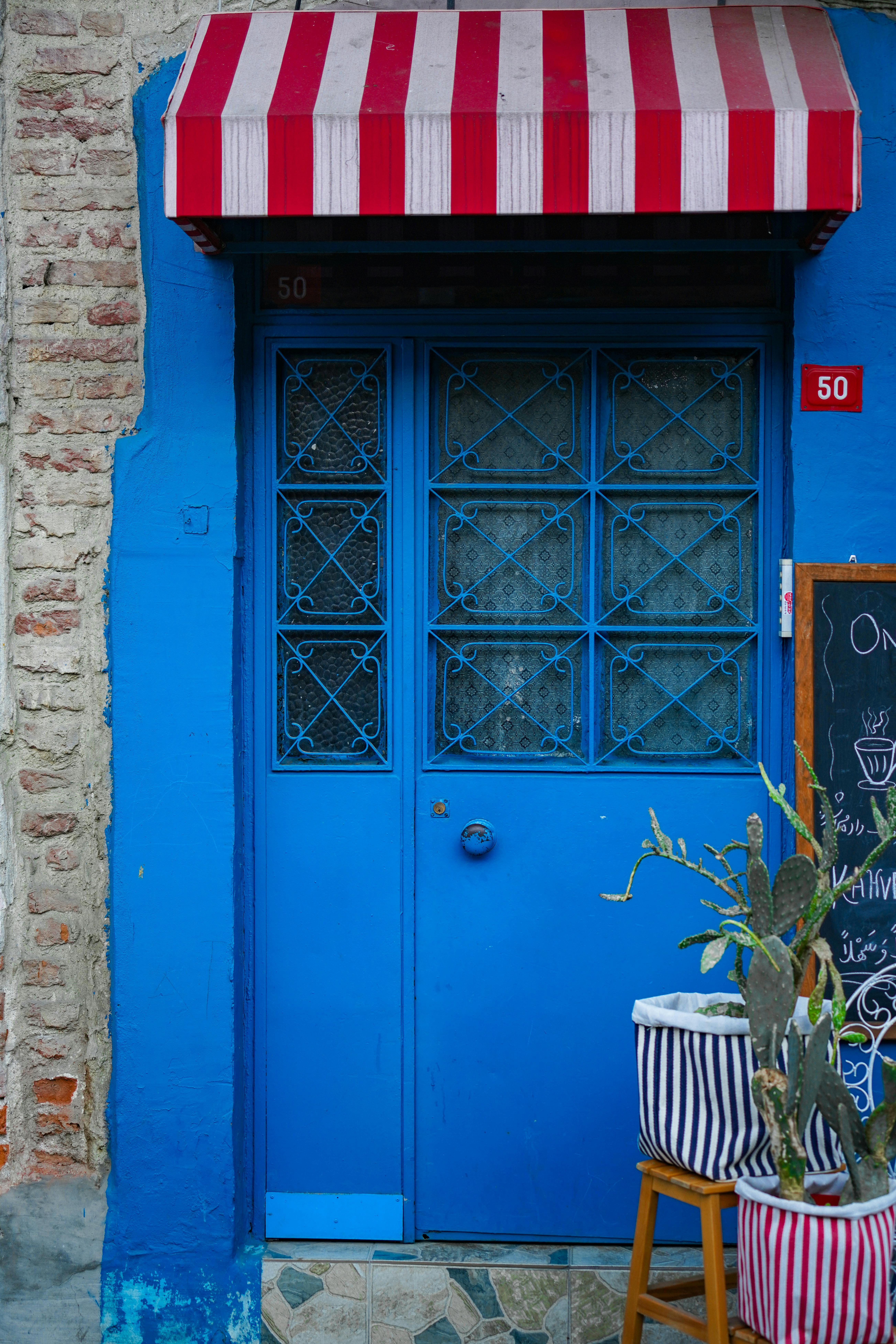 blue wooden door on brown brick wall
