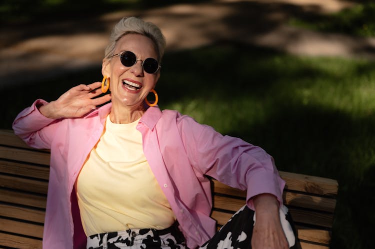 Stylish Elderly Woman Sitting On A Bench