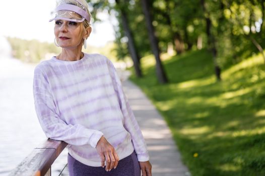 Elderly Woman Leaning on a Railing