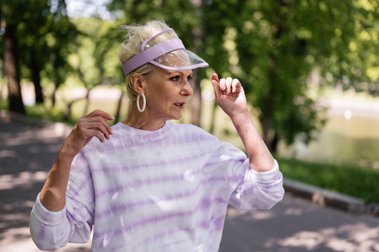 An Elderly Woman Wearing A Visor