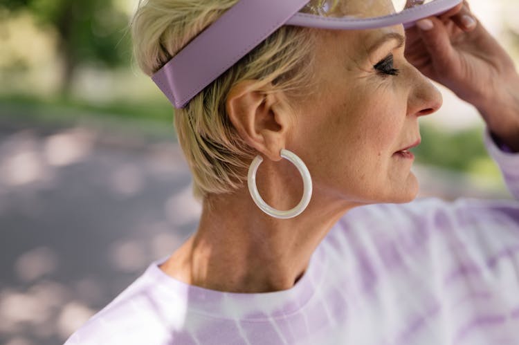 An Elderly Woman Wearing A Sun Visor 