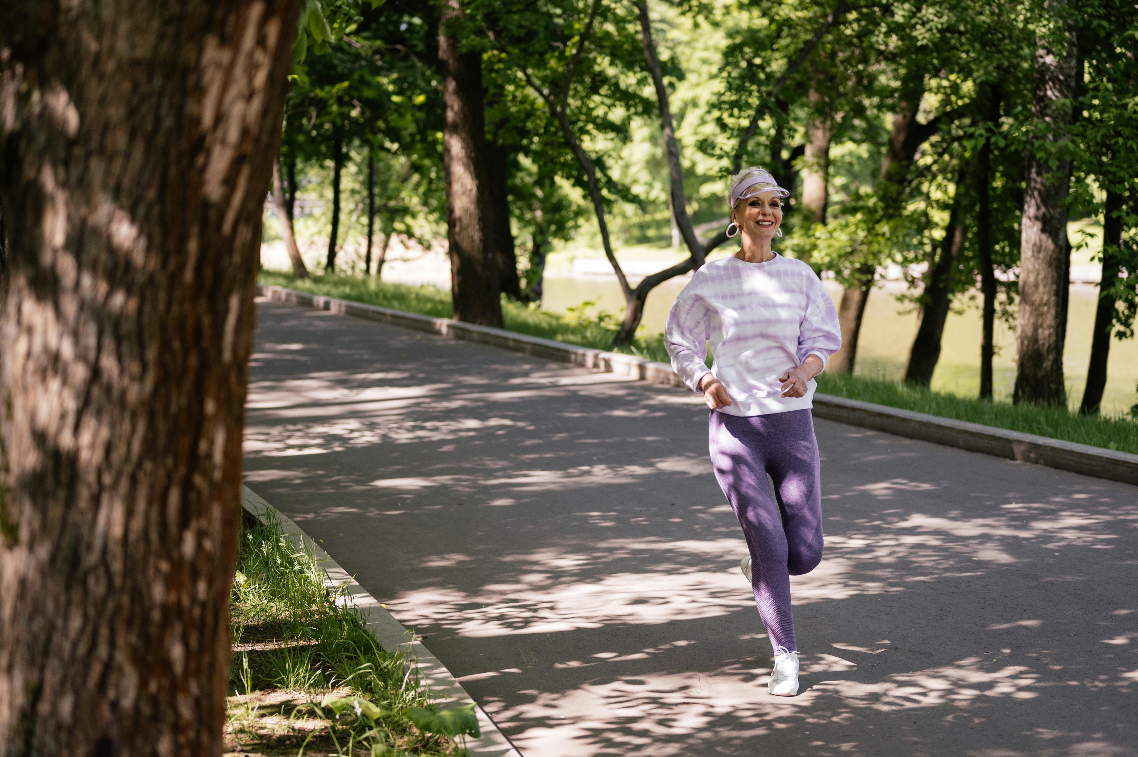 an active elderly woman jogging in the park