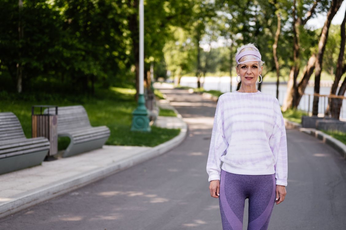 Senior woman walking in a park as part of a daily exercise routine to reverse prediabetes