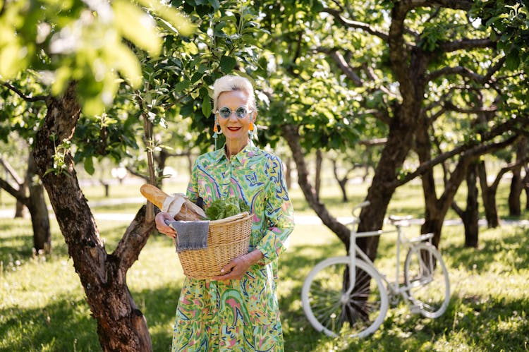 Woman In Green And Blue Dress Holding Brown Woven Basket