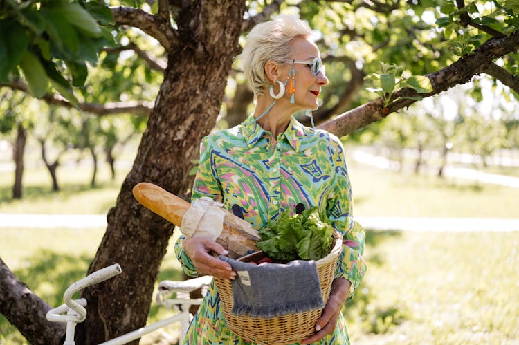 Woman Carrying A Basket With Food