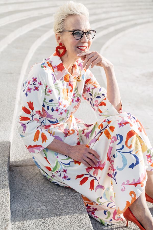 Mature woman in a flowing floral midi dress