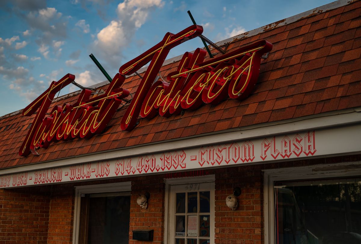 A local business storefront with its sign lit