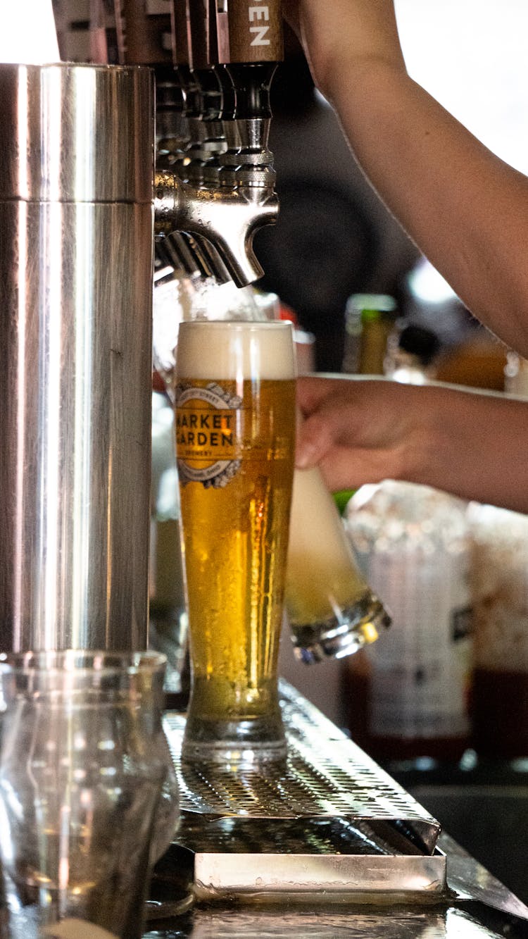 A Person Dispensing Beer From Draft Beer Dispenser 