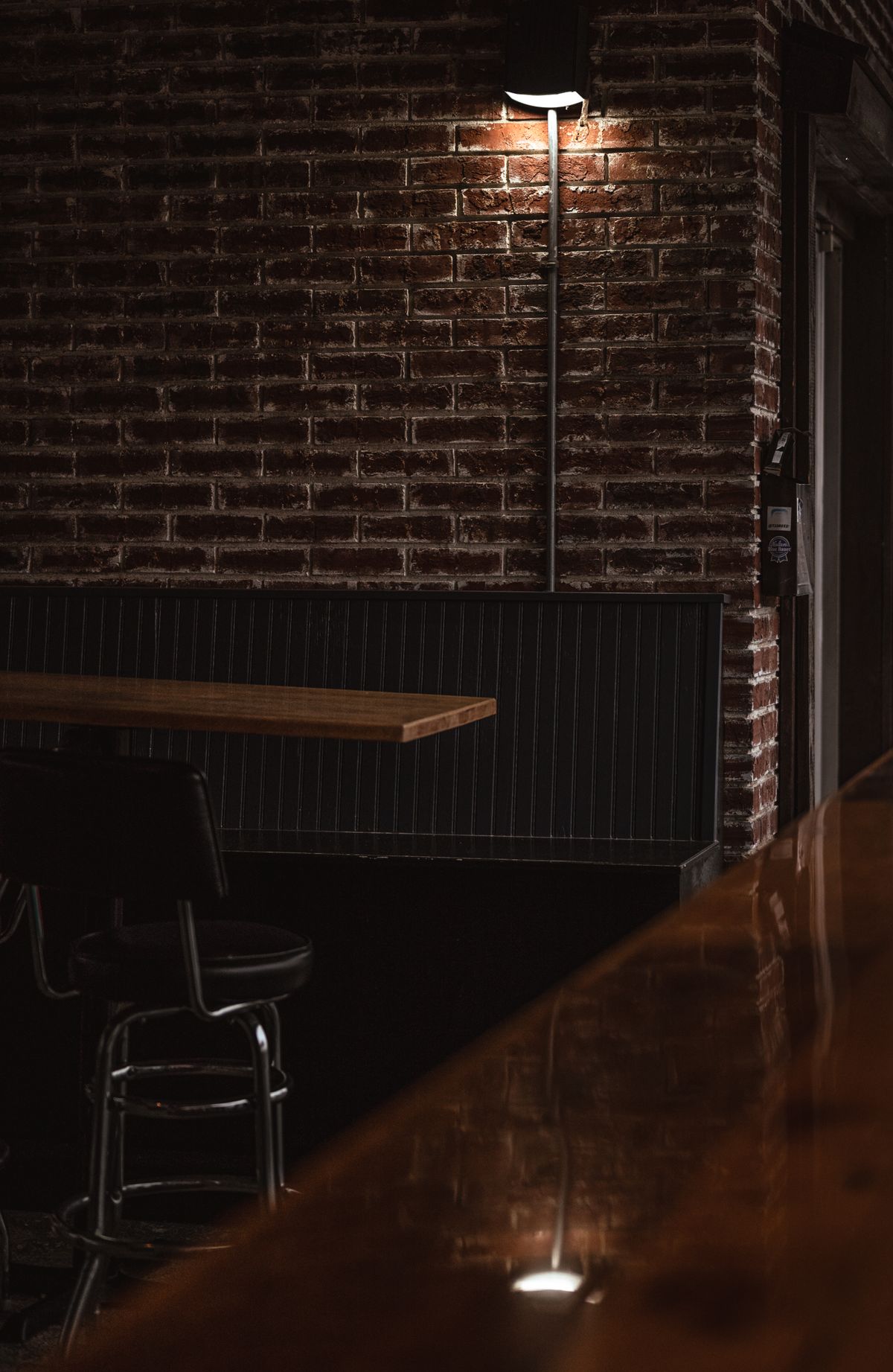 Intimate speakeasy interior with bar shelving and moody lighting