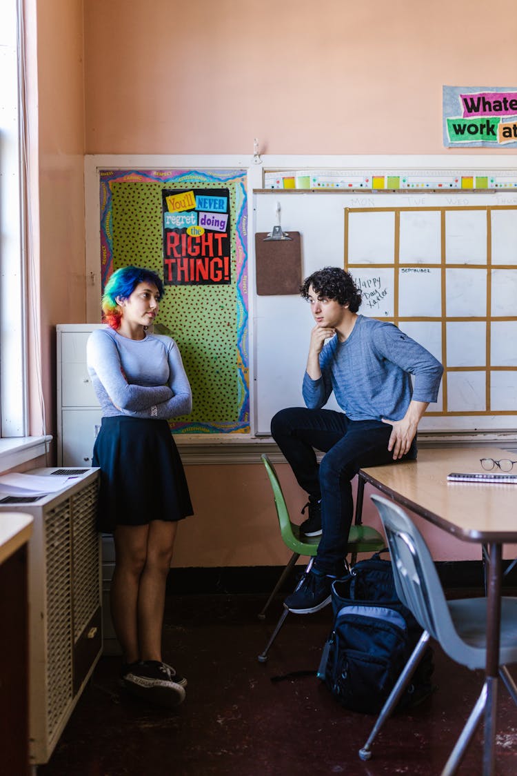 A Man And Woman Talking In The Classroom