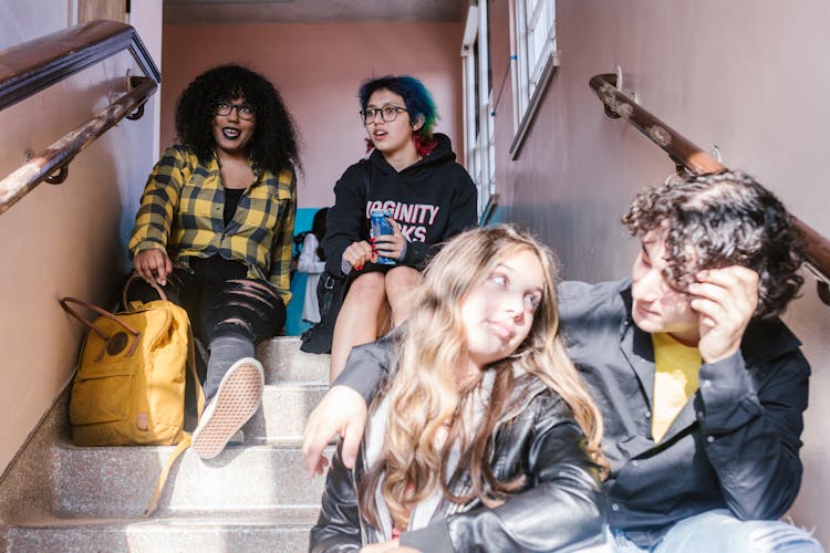 A Students Sitting On The Stairs Together 