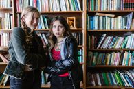 Woman in Black Leather Jacket Beside Woman in Gray Jacket