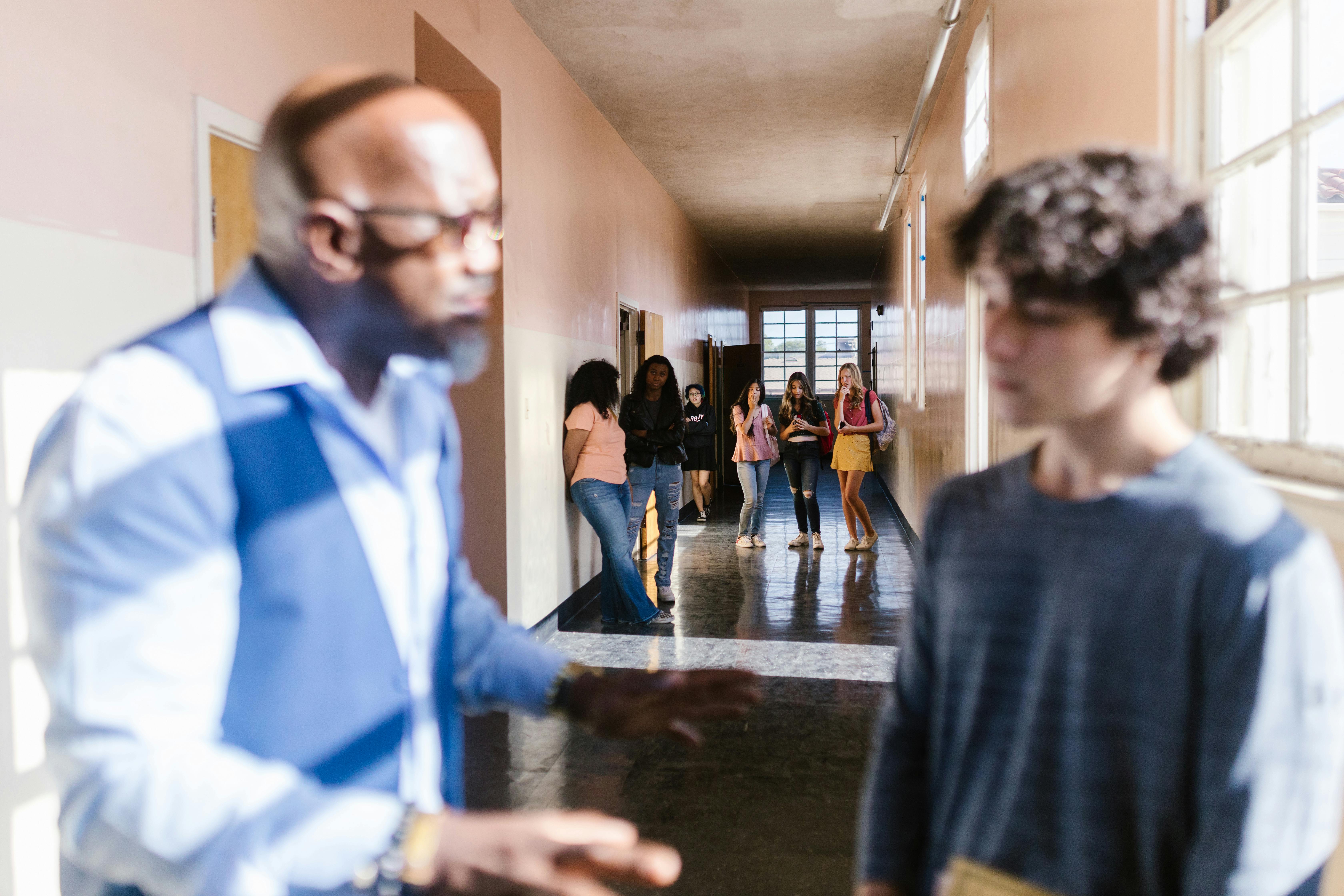 man in blue dress shirt standing near people