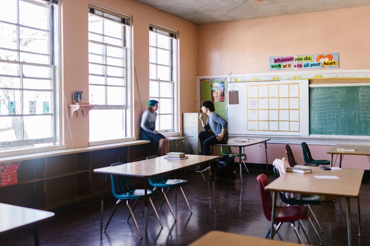 A Man And Woman Talking In The Classroom