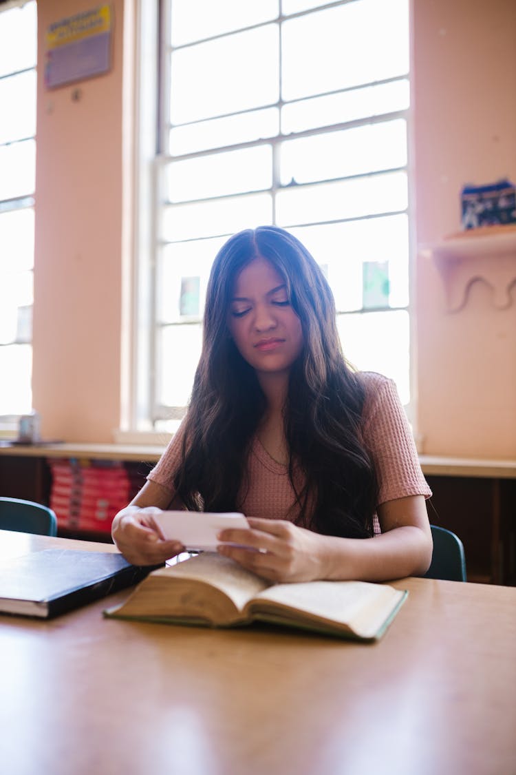 A Female Student Reading A Book