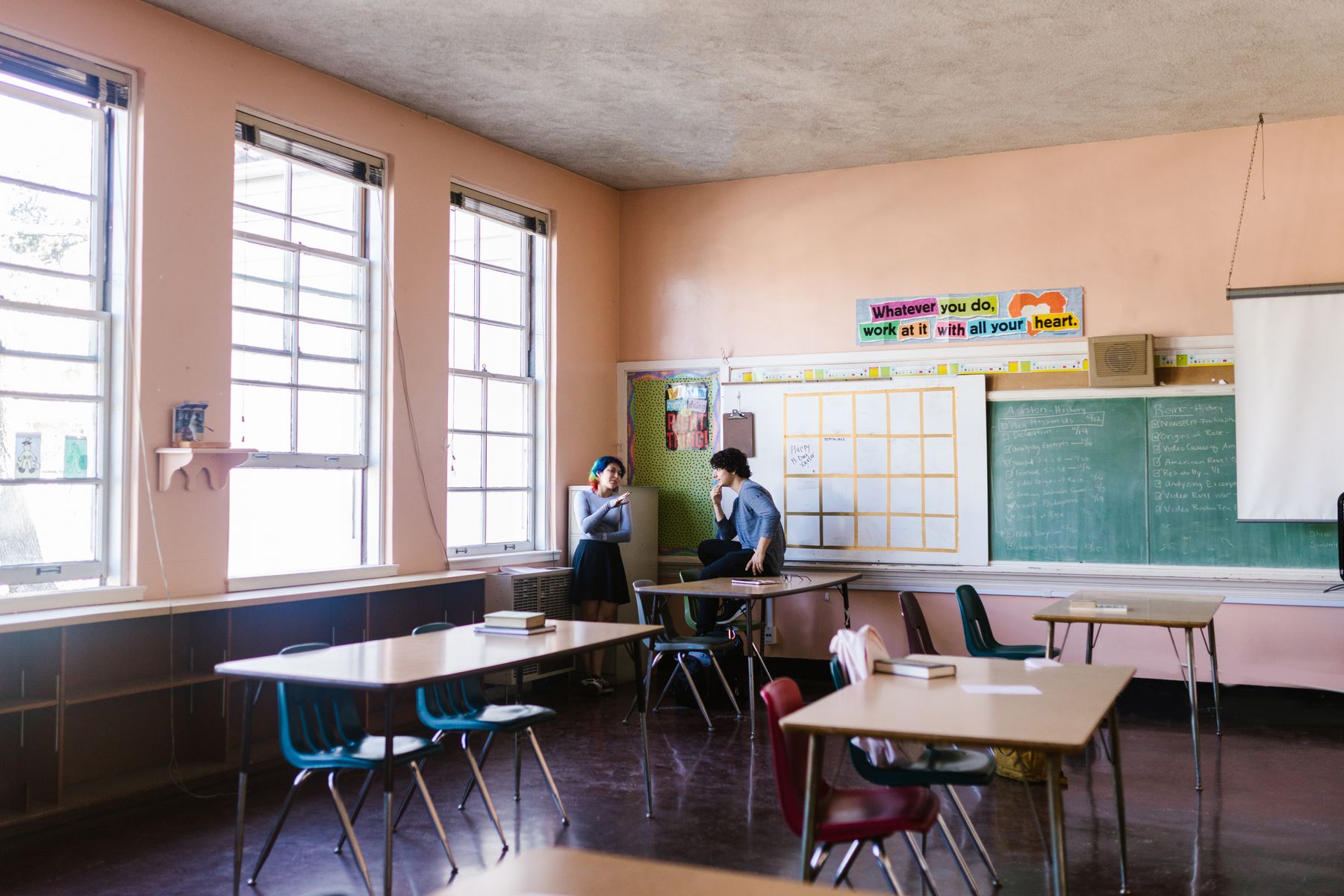 Two learners practising conversation together in a classroom