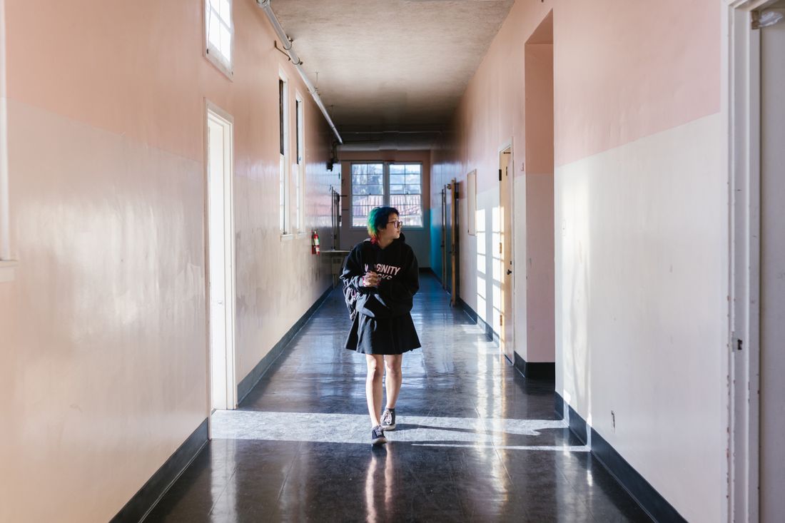 A student walking through a school hallway