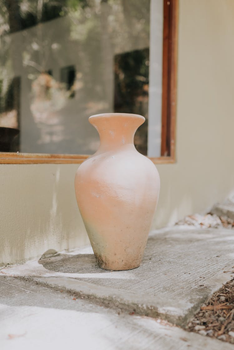 Terracotta Vase Standing On Ground By Window