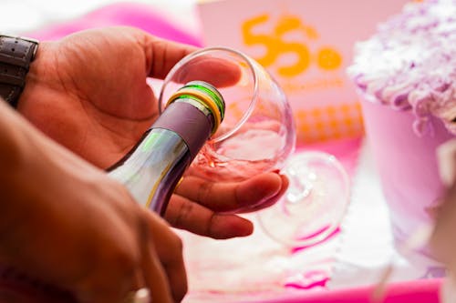 Hands Pouring Alcohol to Glass