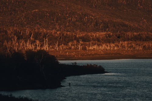 A Mountain near the Lake during Dusk