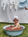 A Baby Bathing in a Basin Filled with Strawberries