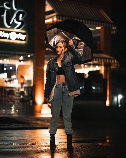 A Woman in Denim Jacket Holding an Umbrella 