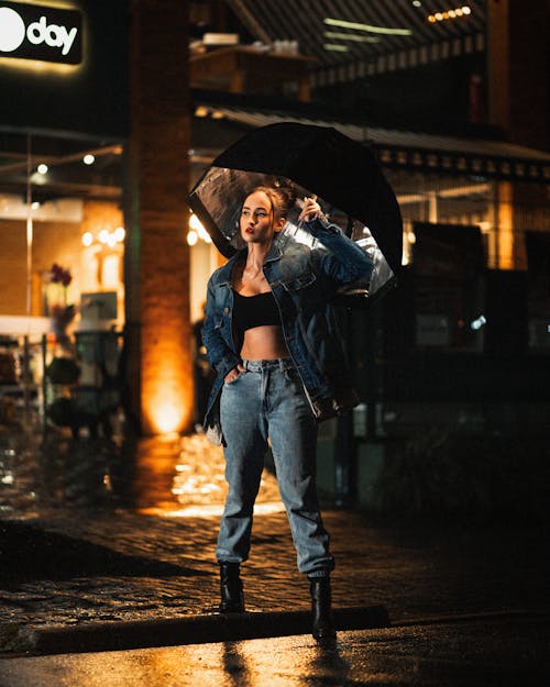 Woman Wearing Denim Clothes while Holding an Umbrella