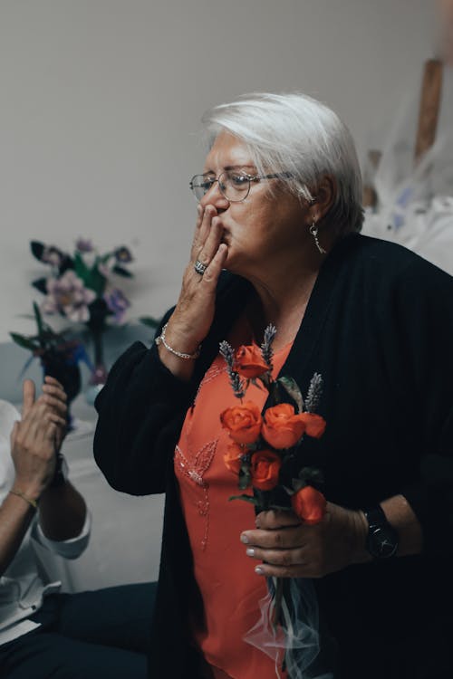 Free Elderly Woman Holding Red Roses Stock Photo
