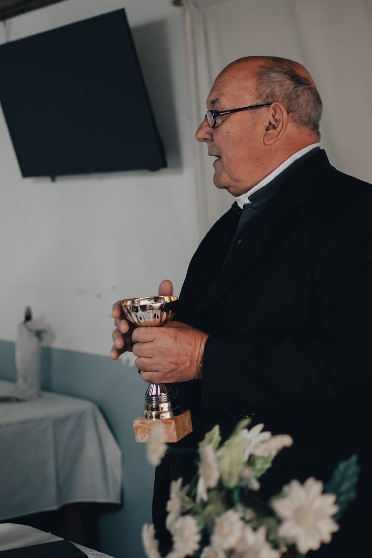 A Priest Celebrating The Holy Mass