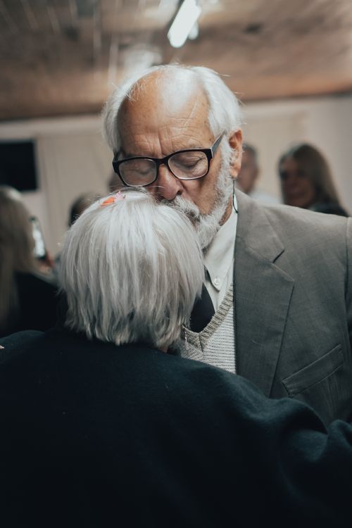 Free Elderly couple embracing, showcasing love and support. Intimate indoor setting. Stock Photo