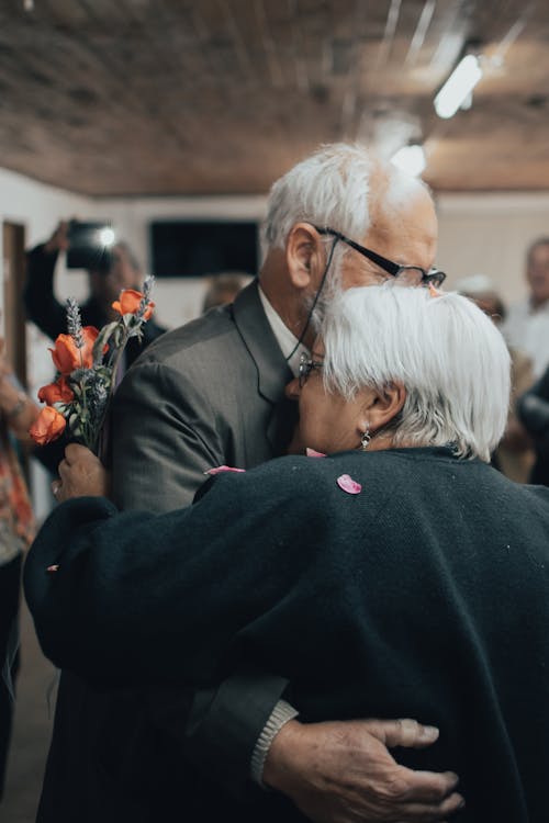 Free Elderly Man and Elderly Woman Embracing Each Other Stock Photo