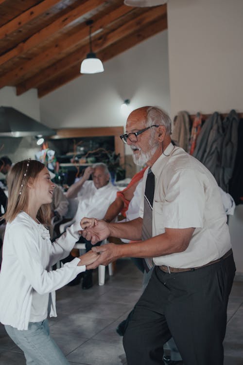 Free An Elderly Man Dancing with His Grandchild Stock Photo