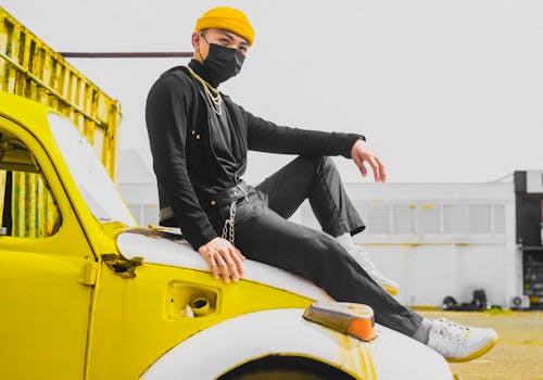 Free A Man in Black Long Sleeves Wearing Beanie while Sitting on the Car Stock Photo