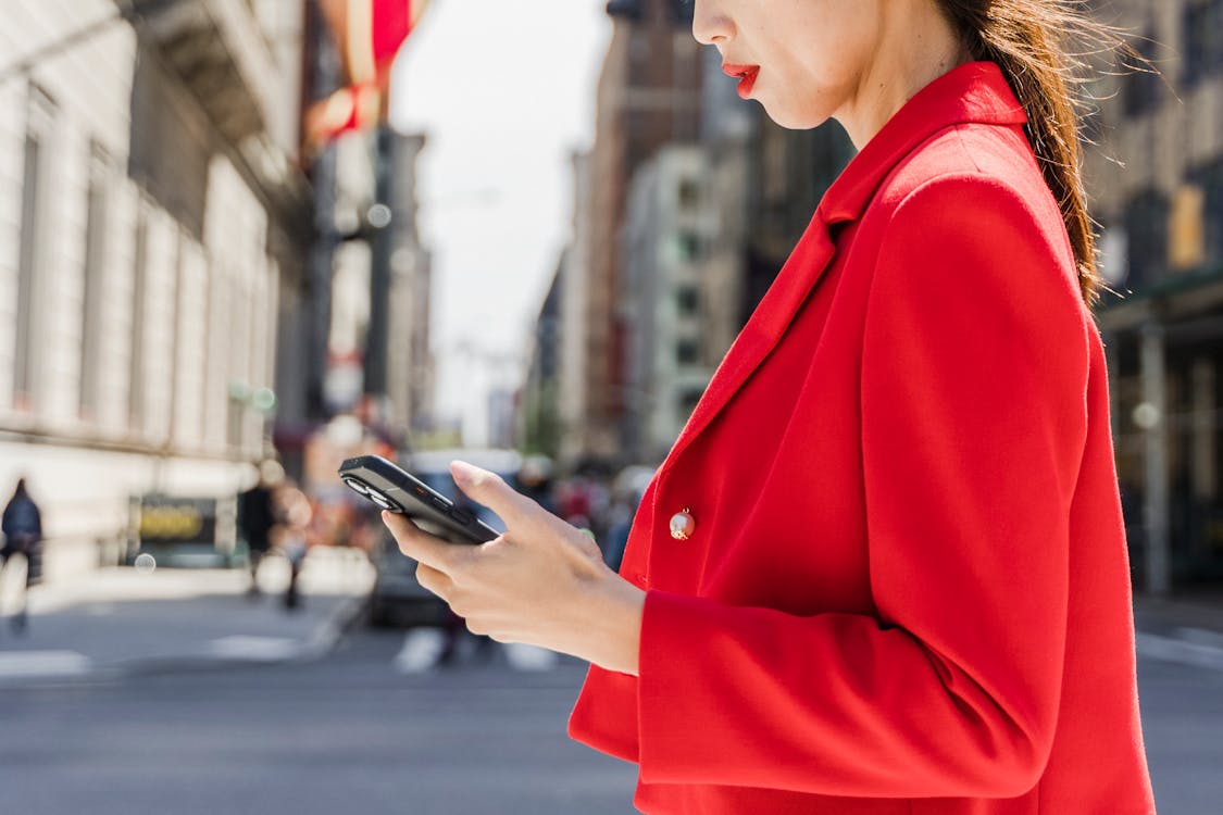 Shallow Focus Photo of a Woman Using Her Smartphone