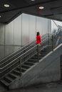 A Person in a Red Blazer Standing on the Stairs