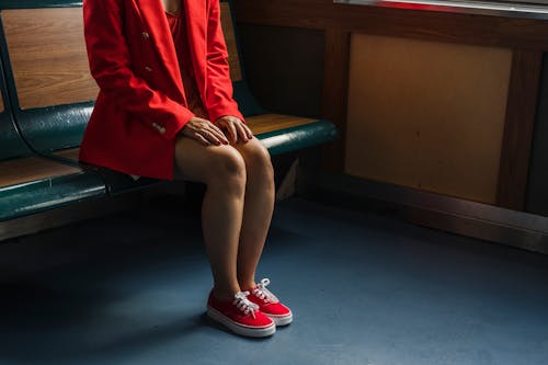 Woman in Red Blazer Sitting on Wooden Bench