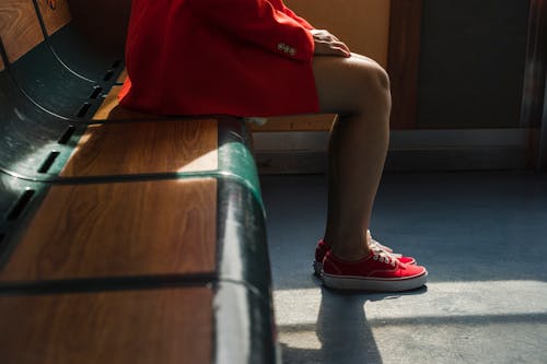 Woman in Red Blazer Sitting on Wooden Bench