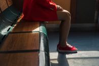 Woman in Red Dress Sitting on Bench