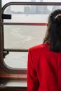 Close-Up Shot of a Woman in Red Blazer near the Window