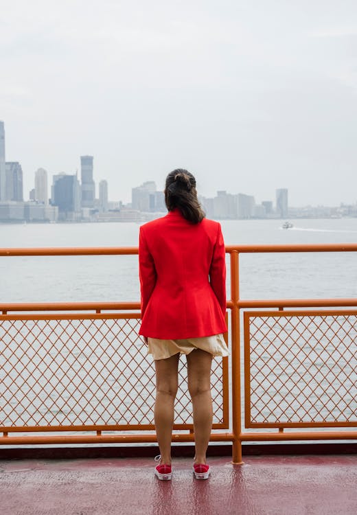 Woman Wearing Red Blazer Standing Beside a Railing · Free Stock Photo