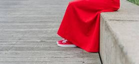 Person in Red Pants Wearing White Sneakers